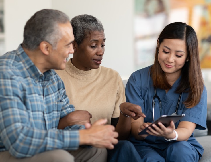 Older couple talking with insurance staff