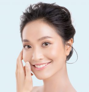 Woman smiling touching her cheek